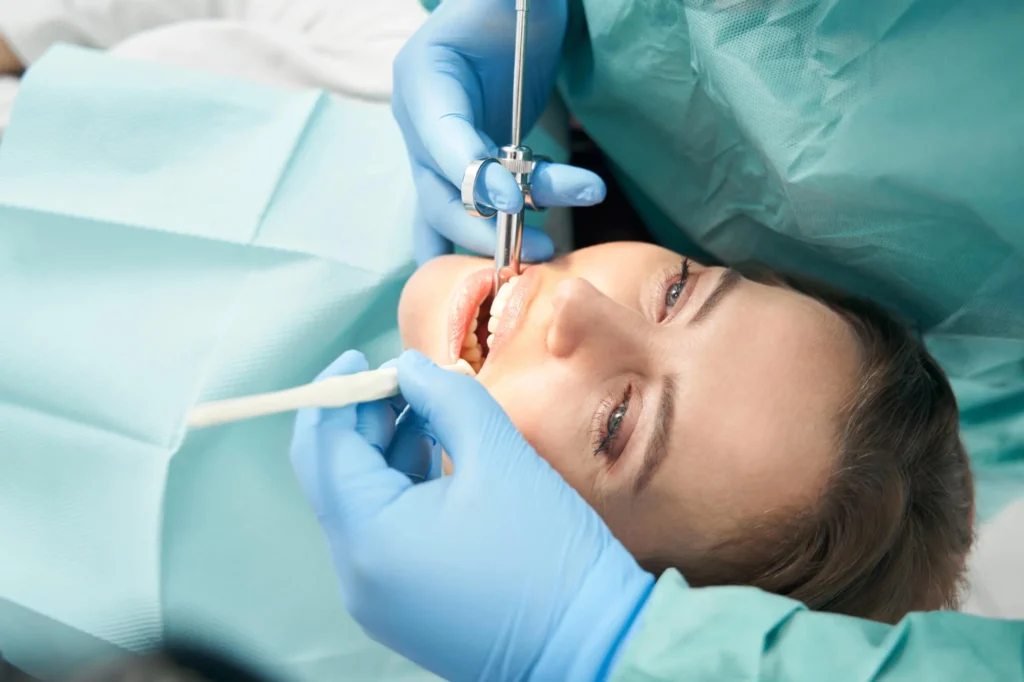 a dentist using sedation on the woman sedation dentistry