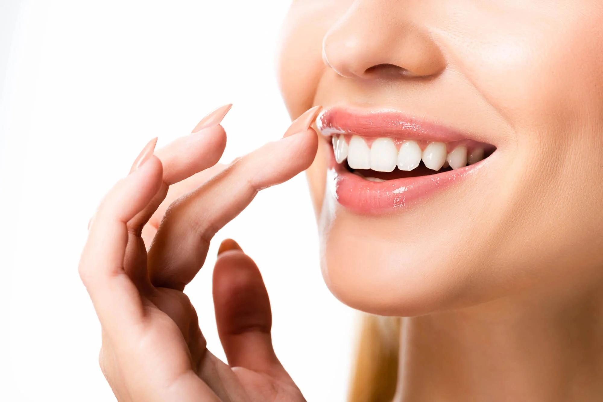 close-up of a woman showing her bright white teeth with a natural smile, highlighting the results of professional dental care. Teeth whitening in Pembroke Pines